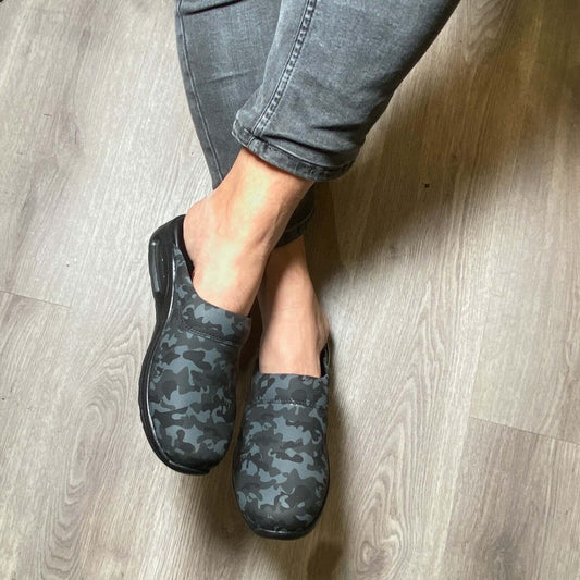 Side profile of camouflage leather clogs with a light Air Clogx sole