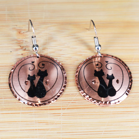 Close-up of the copper texture on handcrafted artisan cat design copper circle earrings