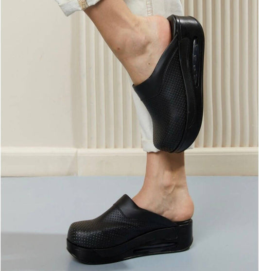 Side profile of handmade black leather clogs with an Air Clogx sole