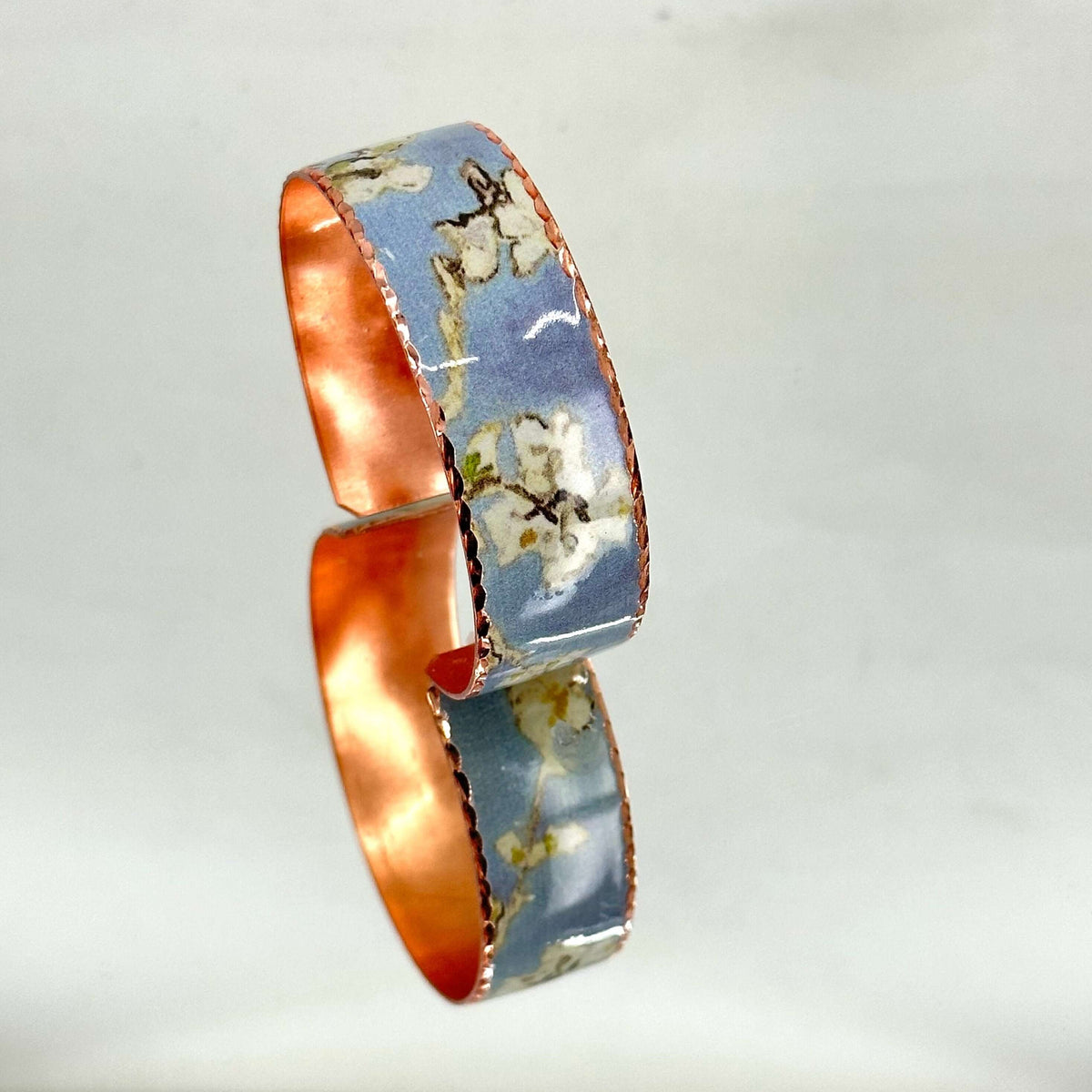 Top-down view of three-piece Van Gogh Almond Blossom copper jewellery set