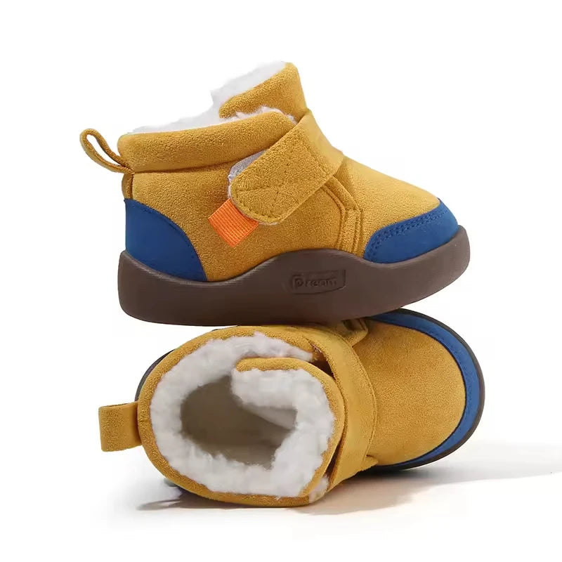 A pair of warm unisex winter baby boots with a non-slip first walker sole placed side by side