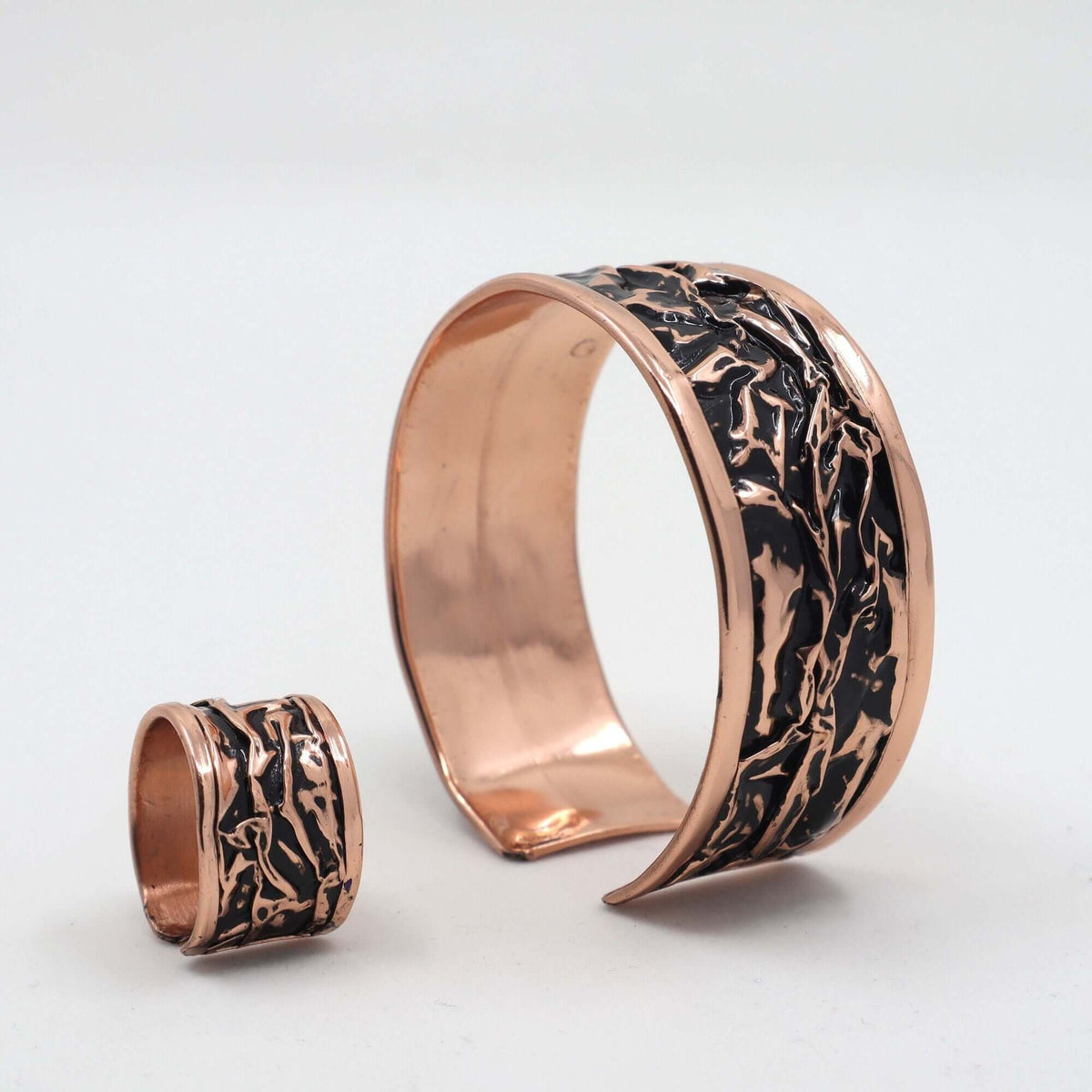 Individual pieces from handcrafted black wrinkled copper jewellery set arranged together