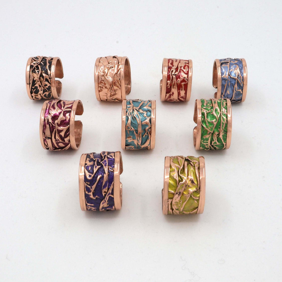 Handmade magenta wrinkled copper adjustable ring displayed on a plain background