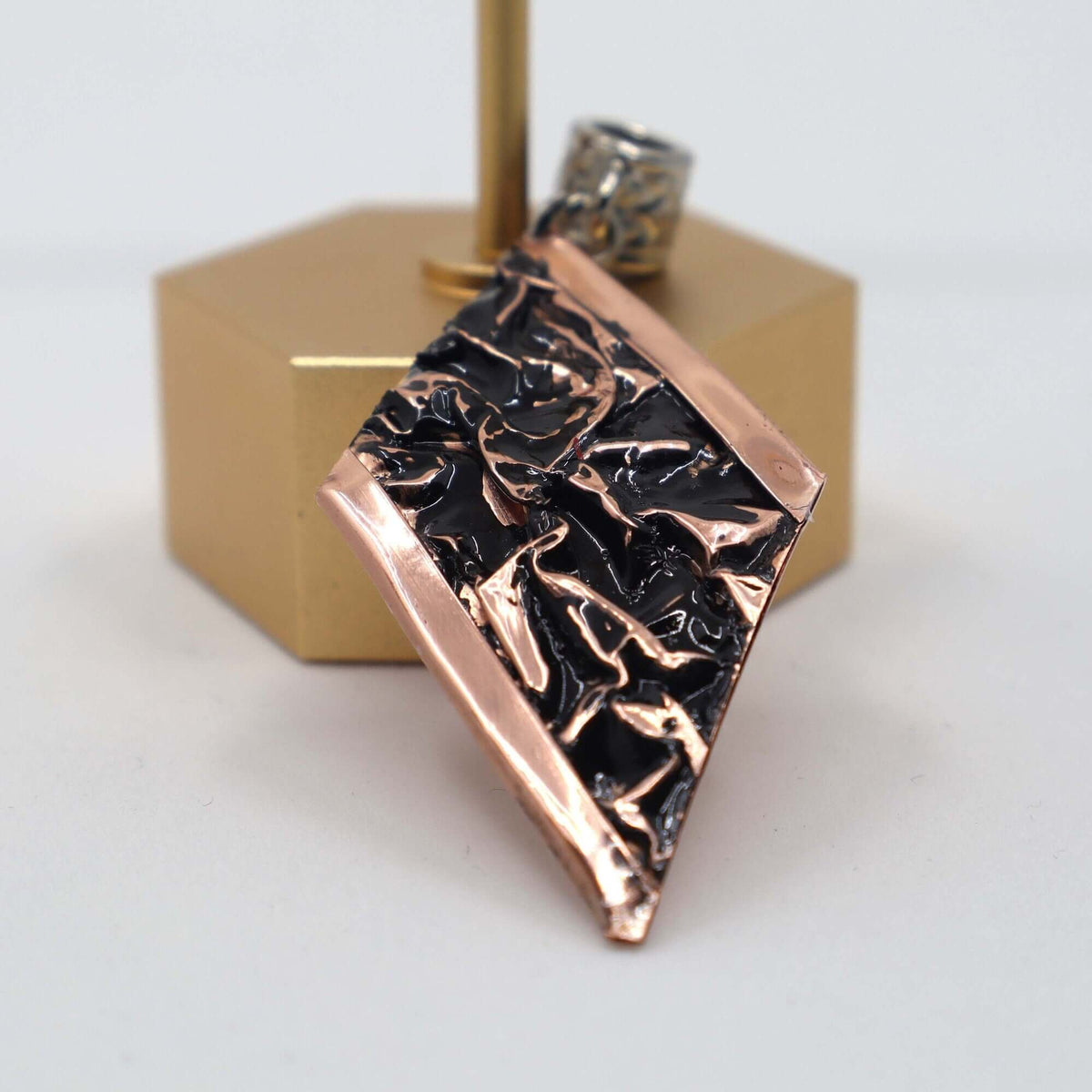 Top-down view of handcrafted black wrinkled copper jewellery set