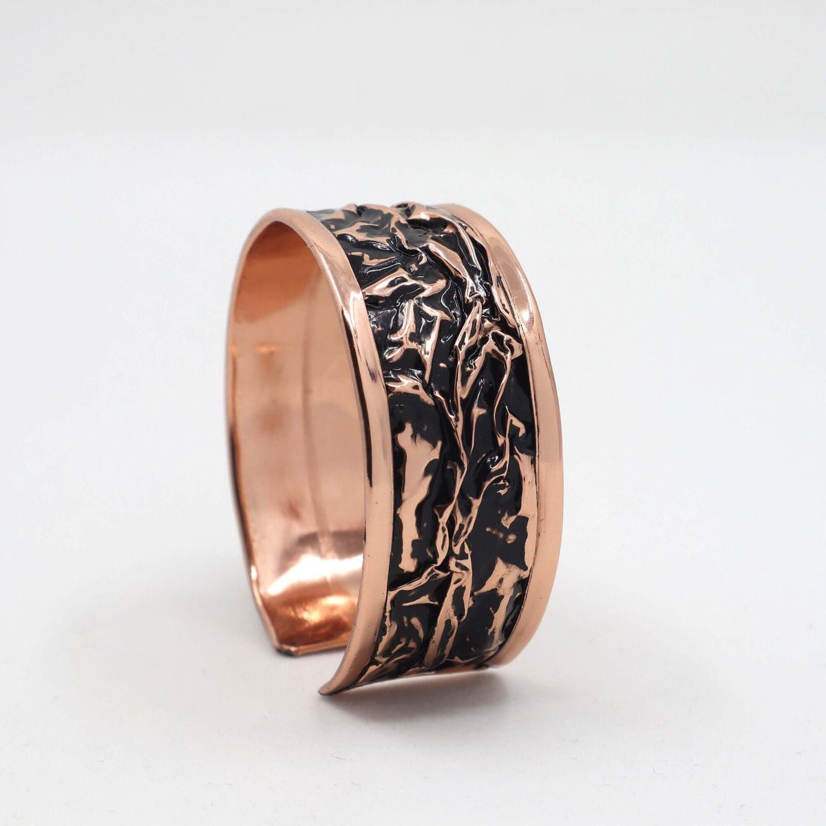 Close-up of one piece from handcrafted black wrinkled copper jewellery set