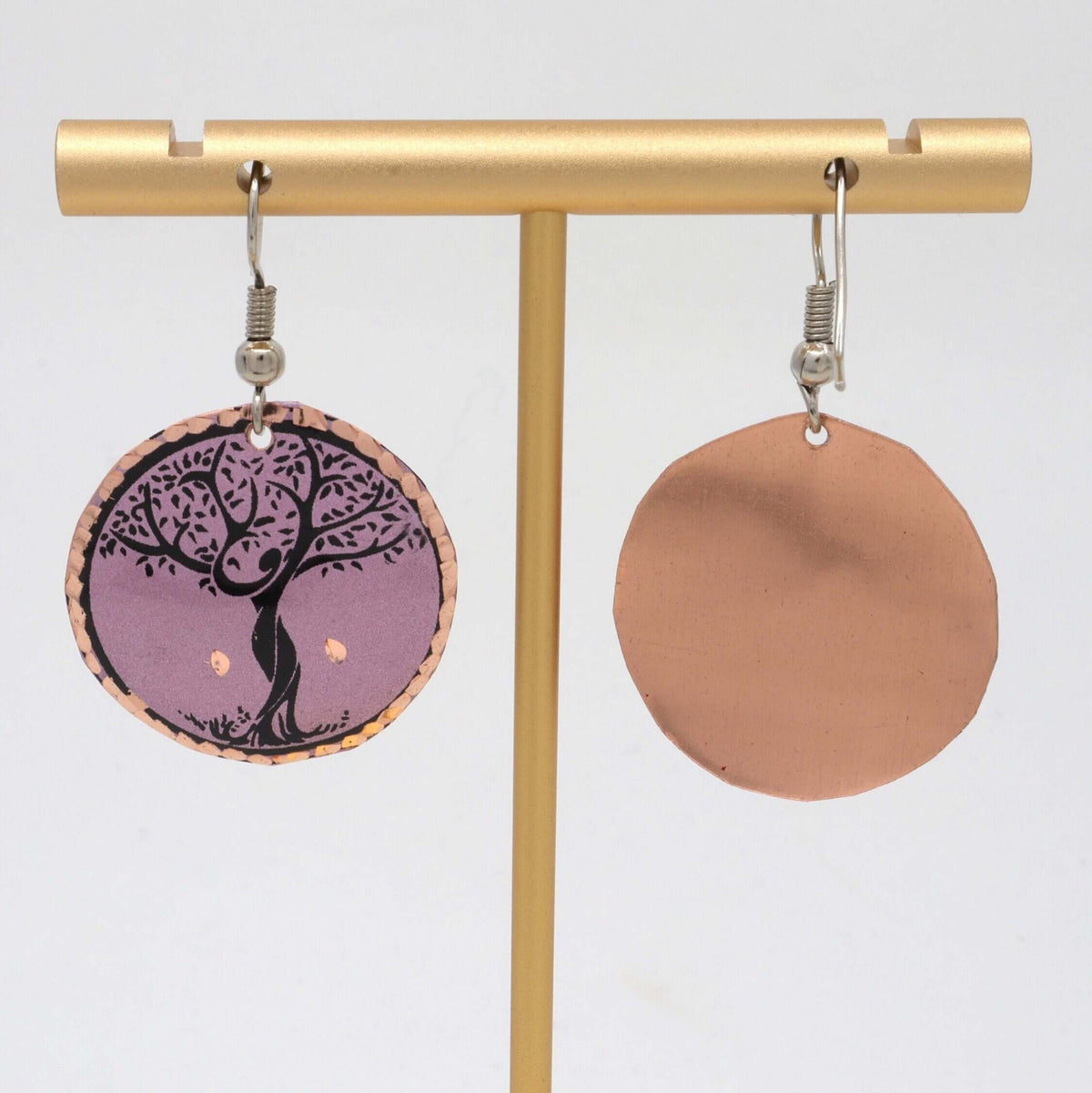 Top-down view of handcrafted lavender tree copper circle earrings