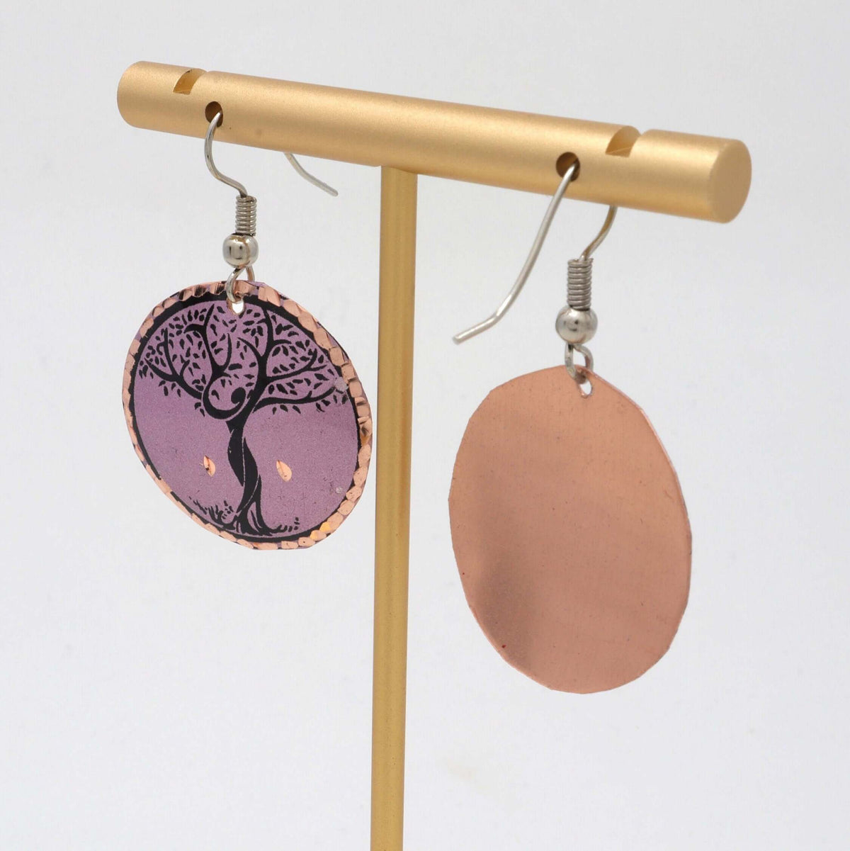 Handcrafted lavender tree copper circle earrings shown next to a hand for scale