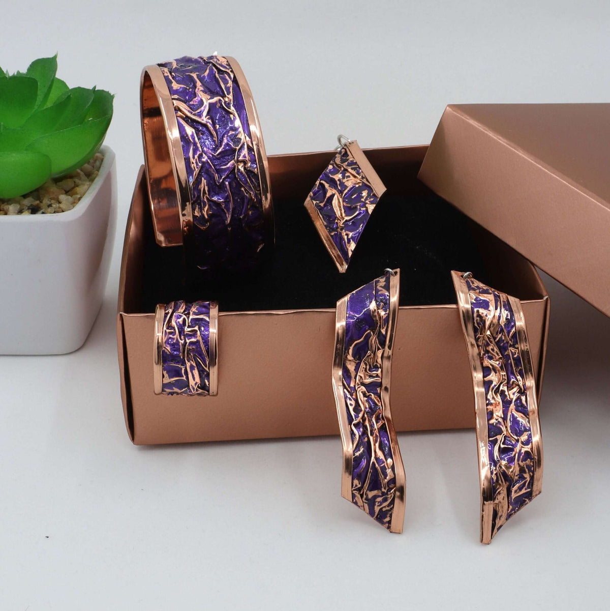 Side angle of four-piece purple wrinkled copper jewellery set