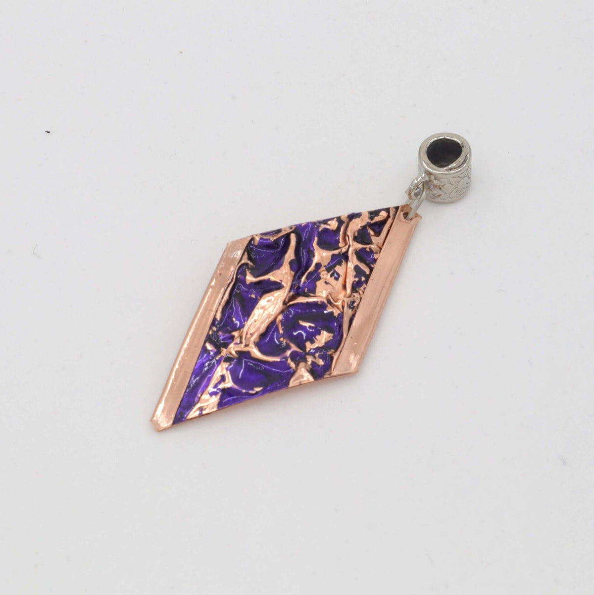 Close-up of one piece from four-piece purple wrinkled copper jewellery set
