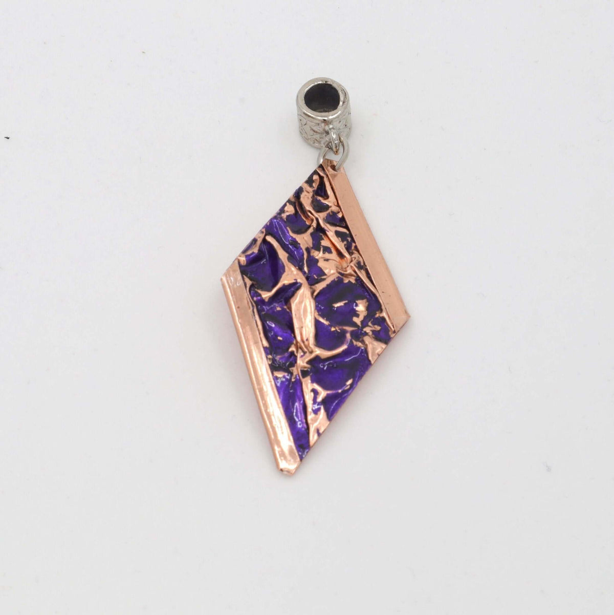 Angled view of four-piece purple wrinkled copper jewellery set