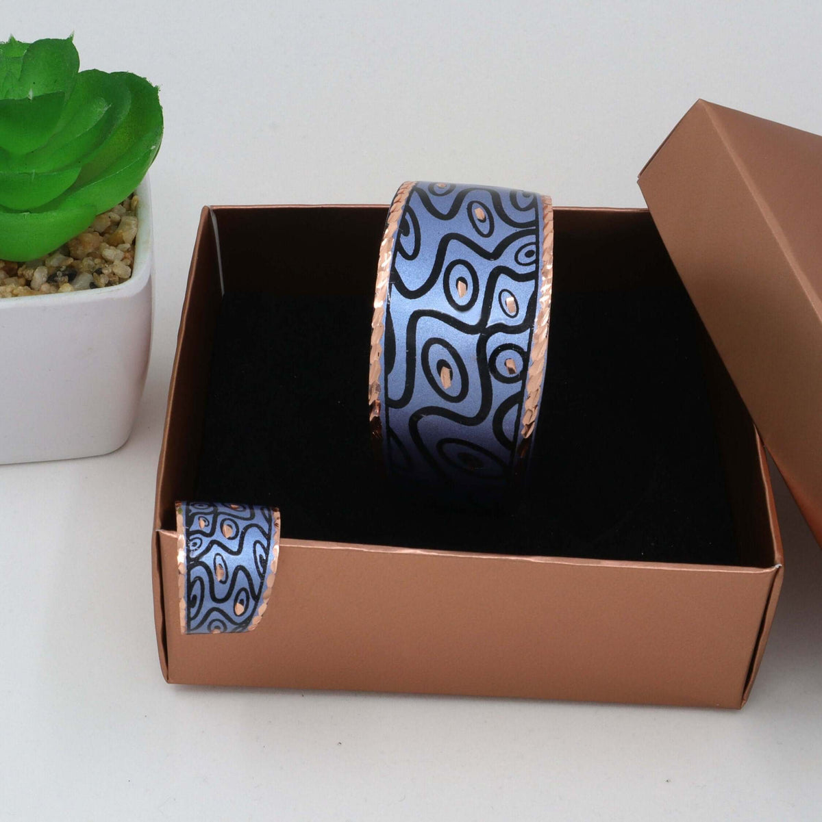 Individual pieces from handcrafted blue curvy copper statement jewellery set arranged together