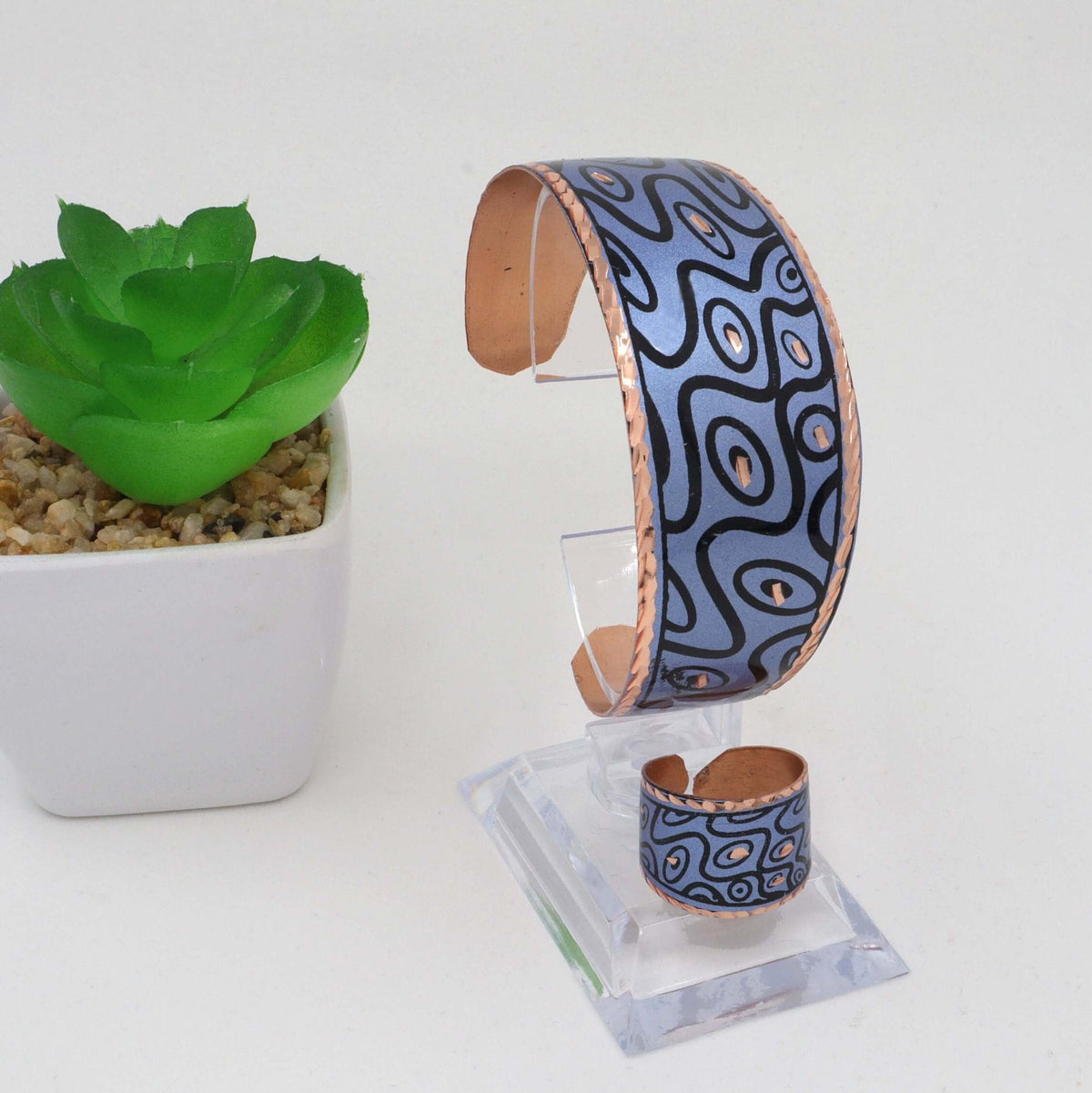 Side angle of handcrafted blue curvy copper statement jewellery set