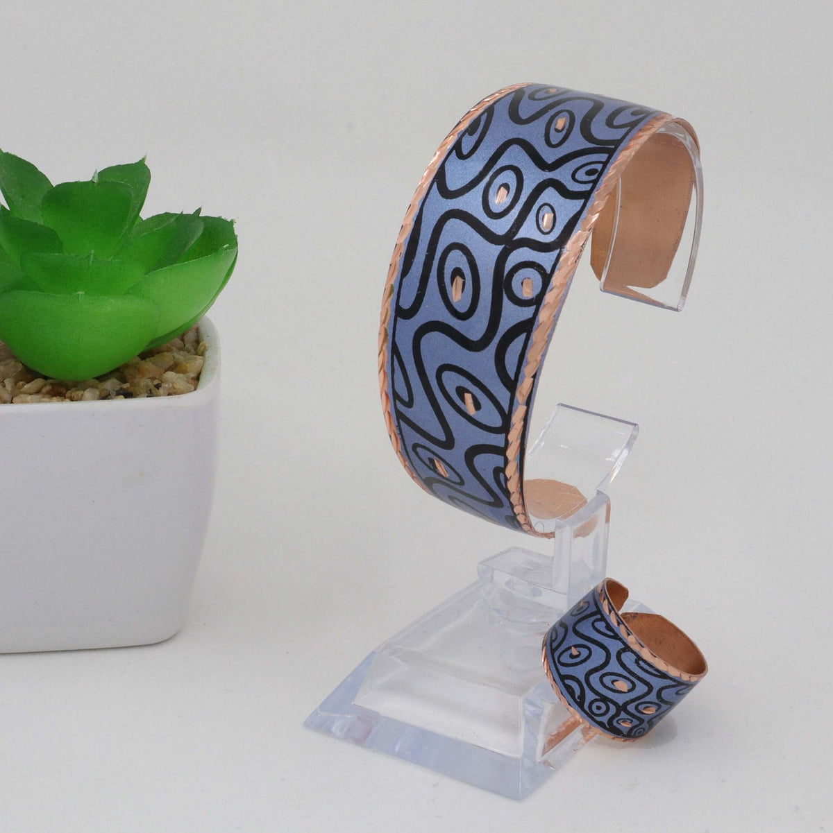 Top-down view of handcrafted blue curvy copper statement jewellery set