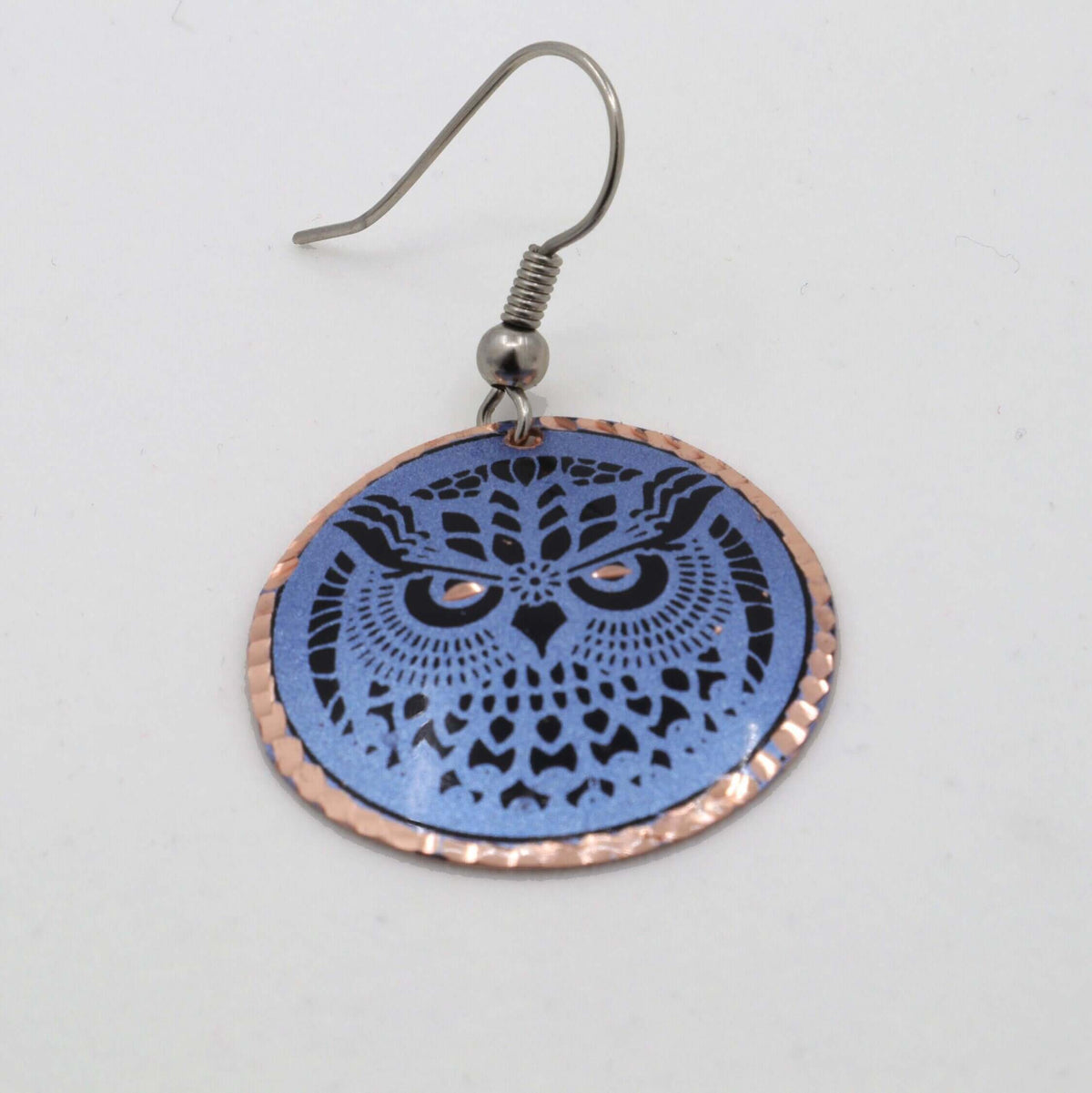 Handcrafted blue owl copper circle earrings displayed on a plain background