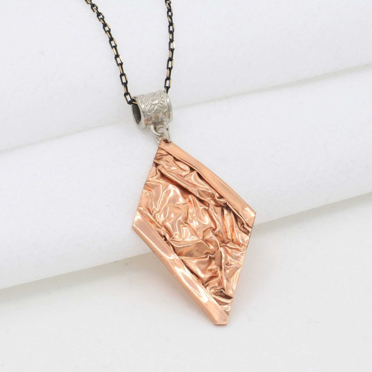 Side angle of handcrafted wrinkled copper jewellery set