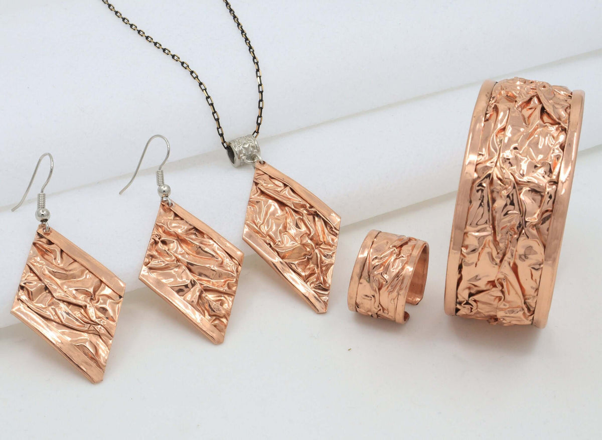 Earrings from the handcrafted wrinkled copper jewellery set worn on the ear