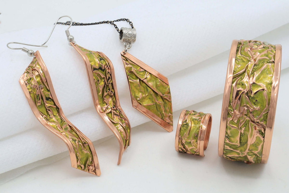 Front view of four-piece yellow wrinkled copper jewellery set