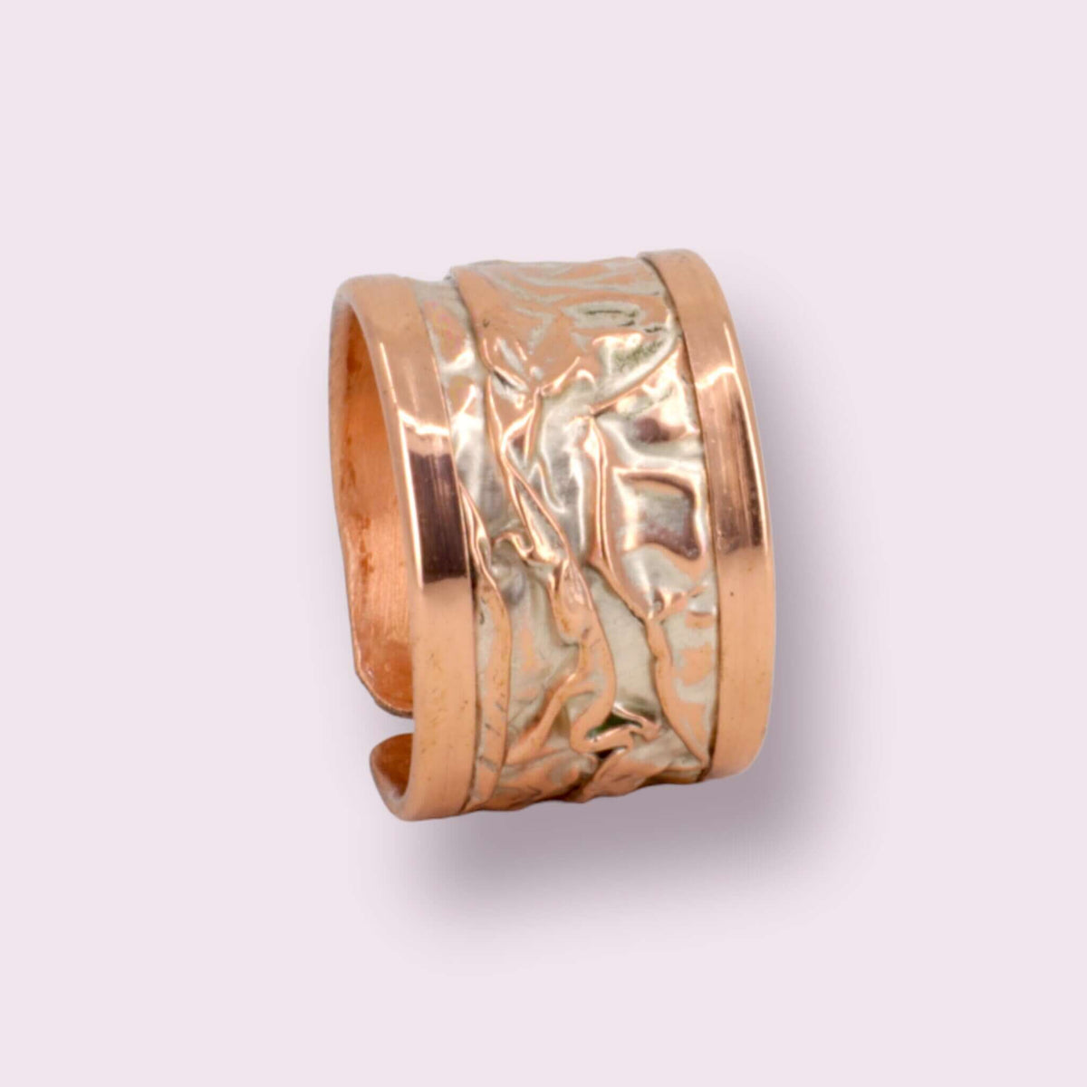 Artisan silver wrinkled copper adjustable ring shown next to a hand for scale