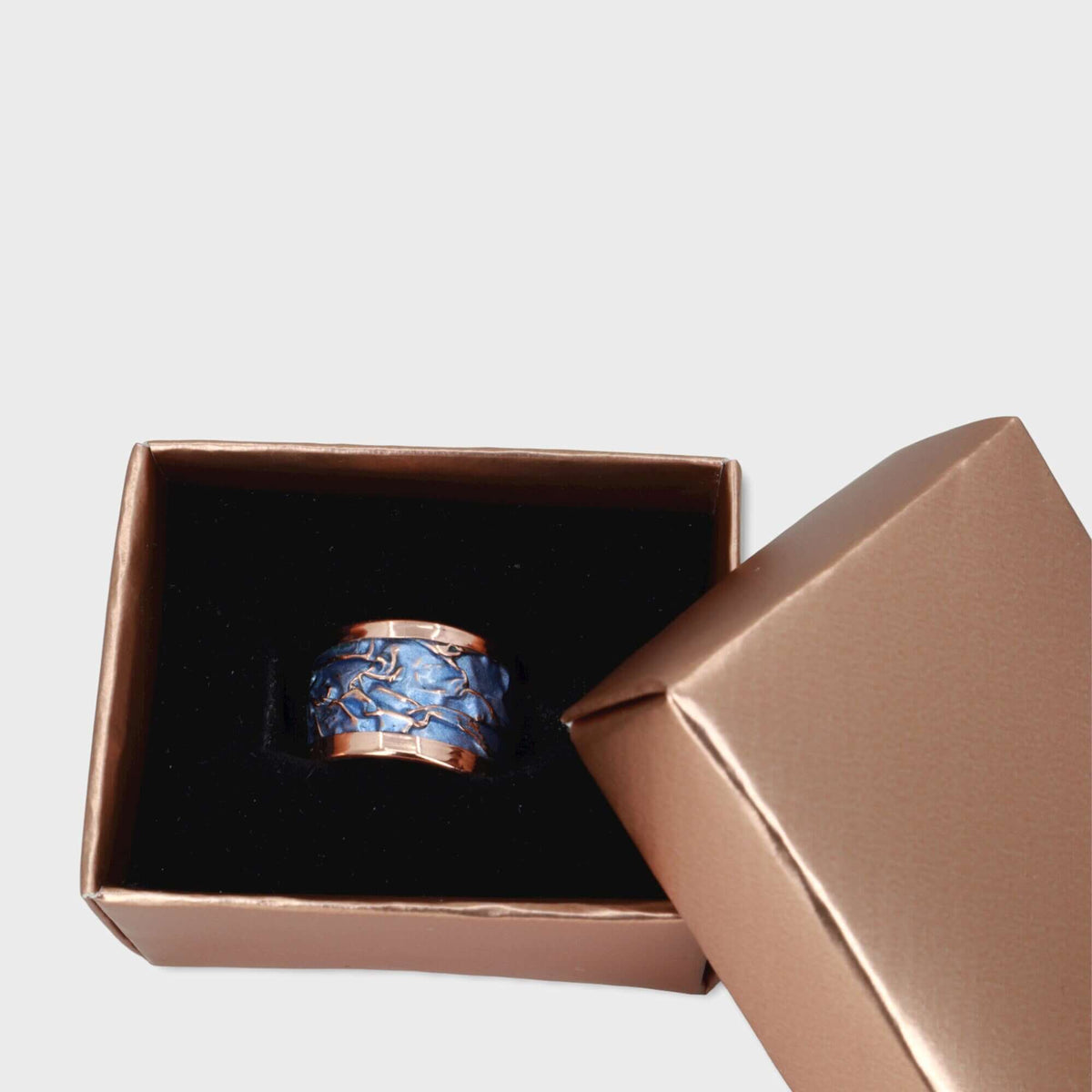 Side angle of handmade blue wrinkled copper adjustable ring