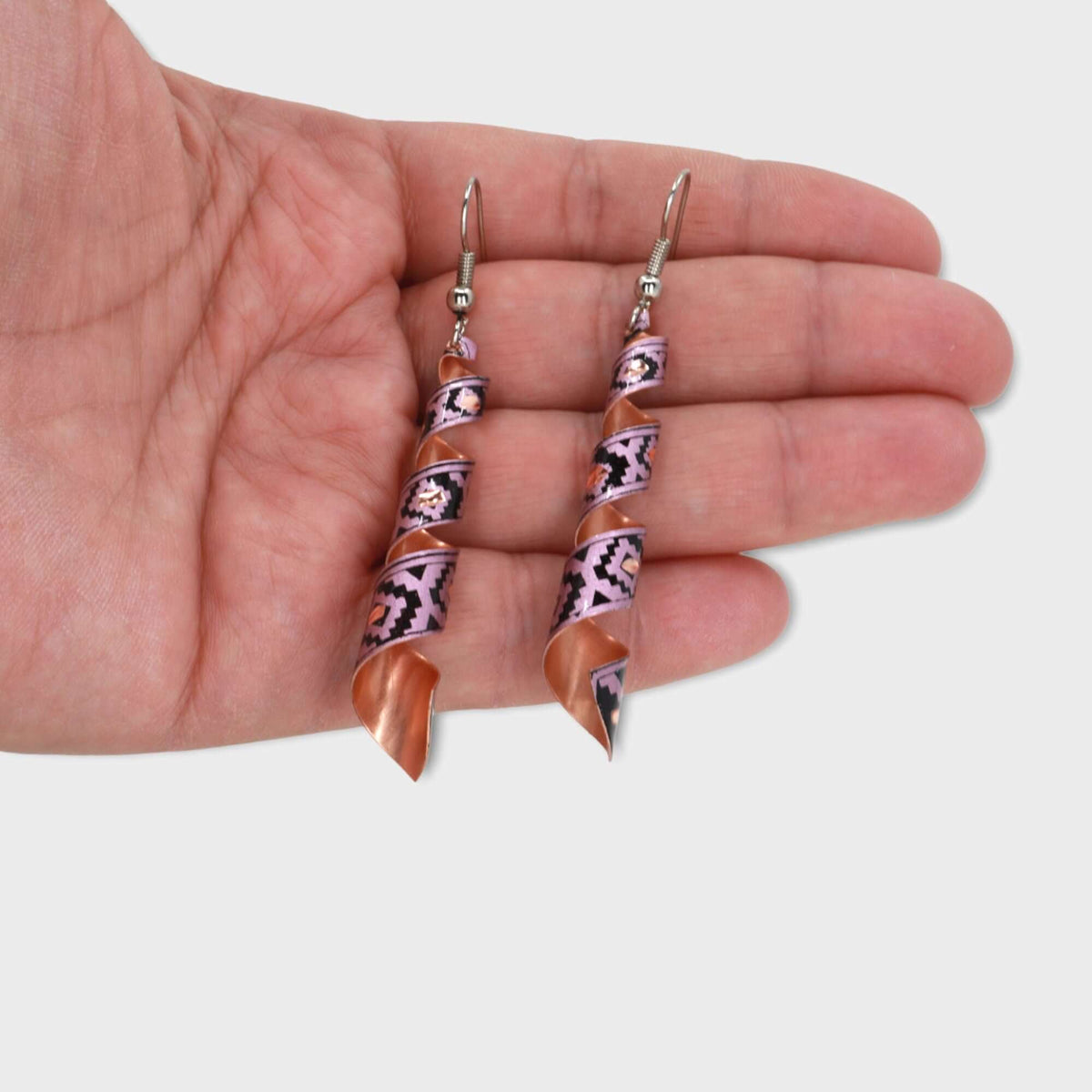 Handcrafted artisan pink auger copper earrings displayed on a plain background
