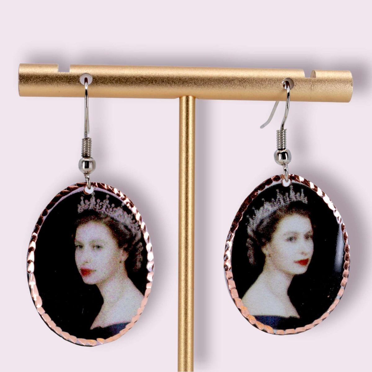 Top-down view of artisan Queen Elizabeth II copper oval earrings
