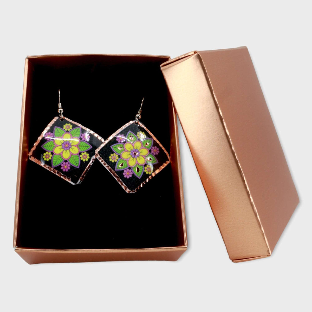 Handcrafted square yellow flower copper earrings displayed on a plain background