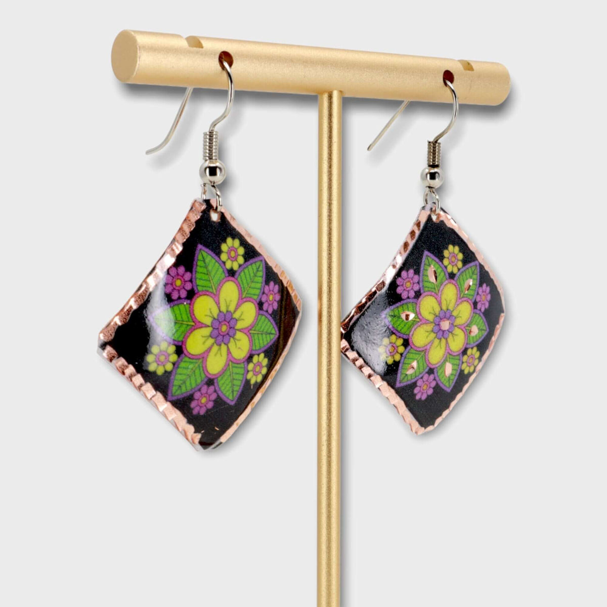 Top-down view of handcrafted square yellow flower copper earrings