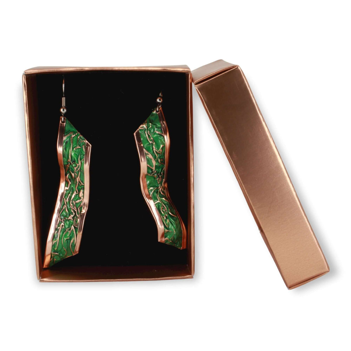 Handcrafted artisan green wrinkled copper earrings worn on the ear