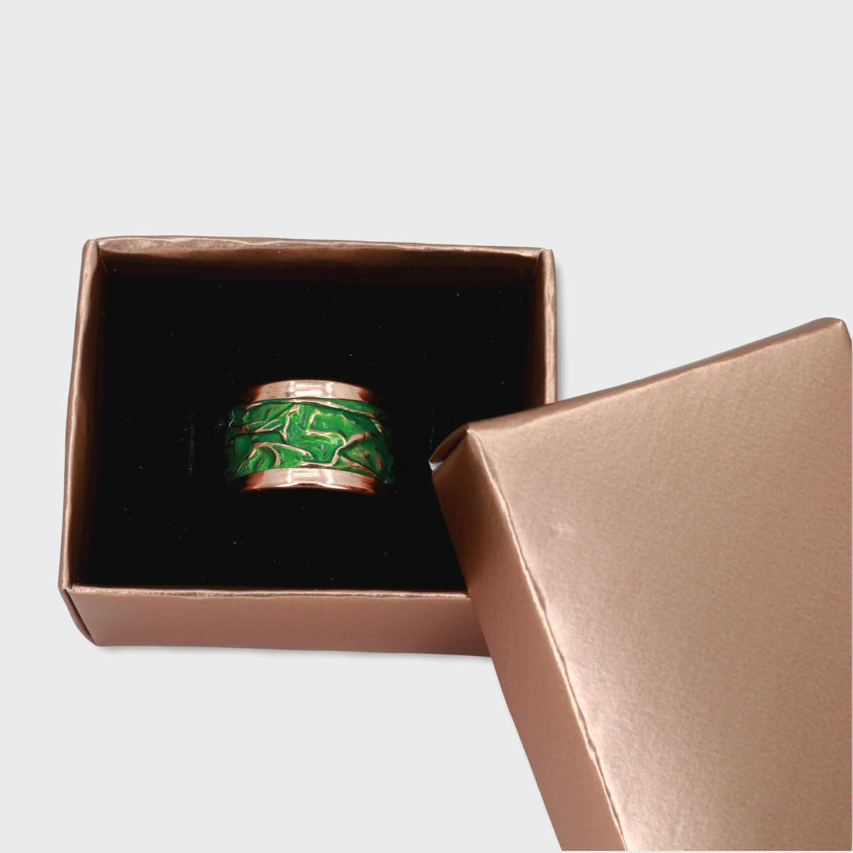 Top-down view of handmade green wrinkled copper adjustable ring