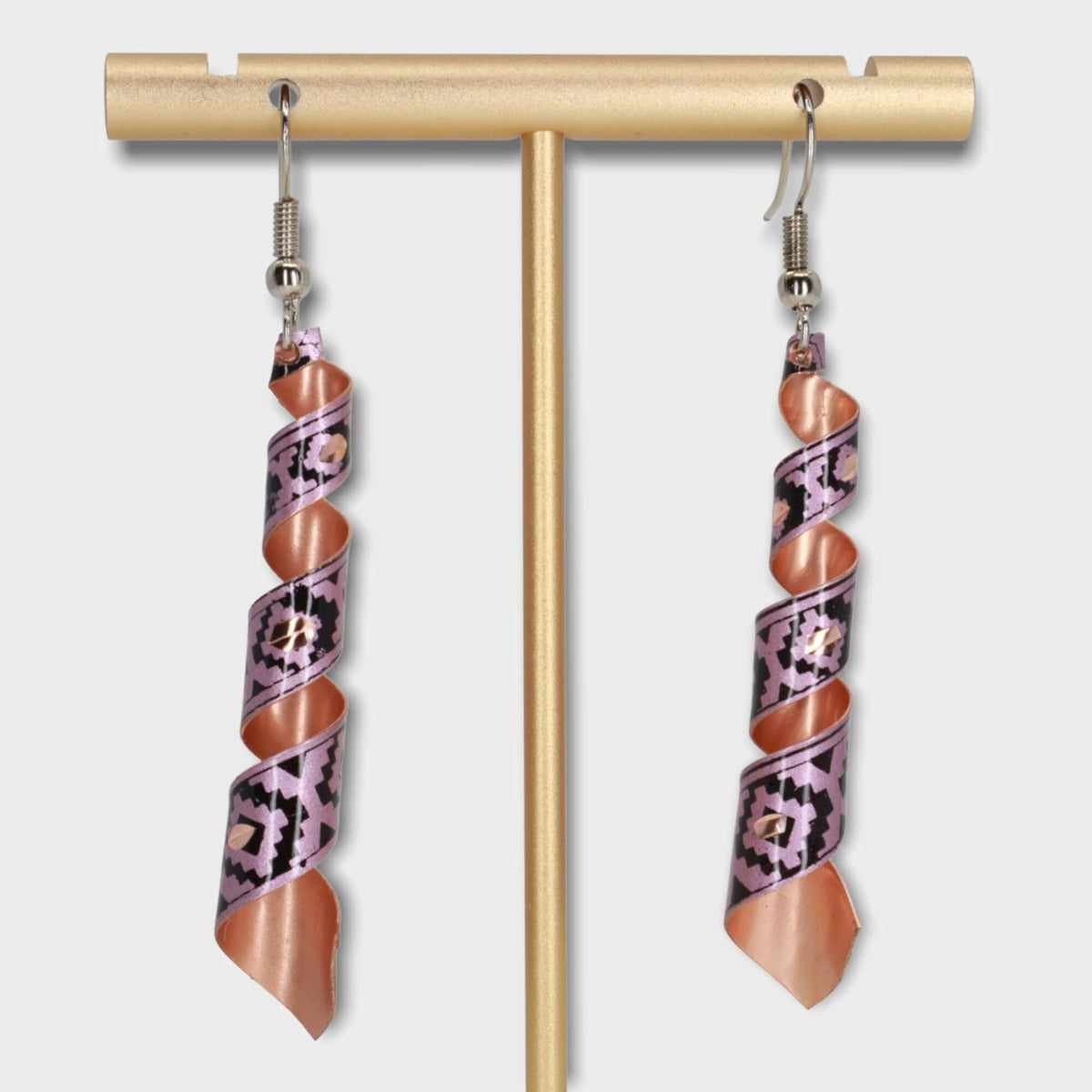Handcrafted artisan pink auger copper earrings worn on the ear