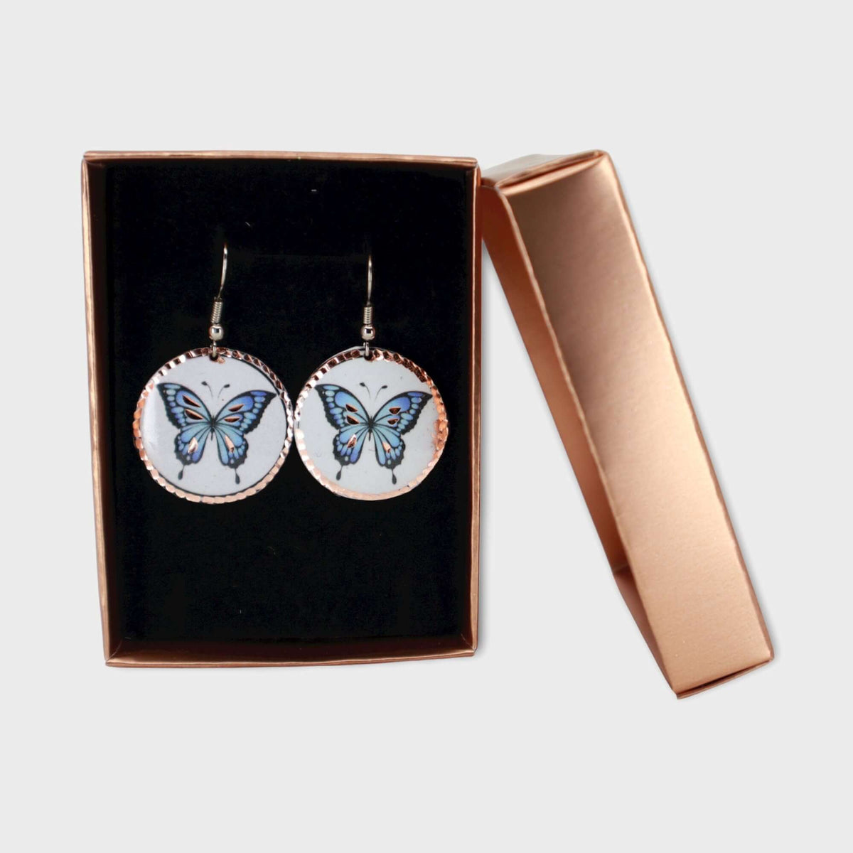 Side angle of handcrafted butterfly copper circle earrings