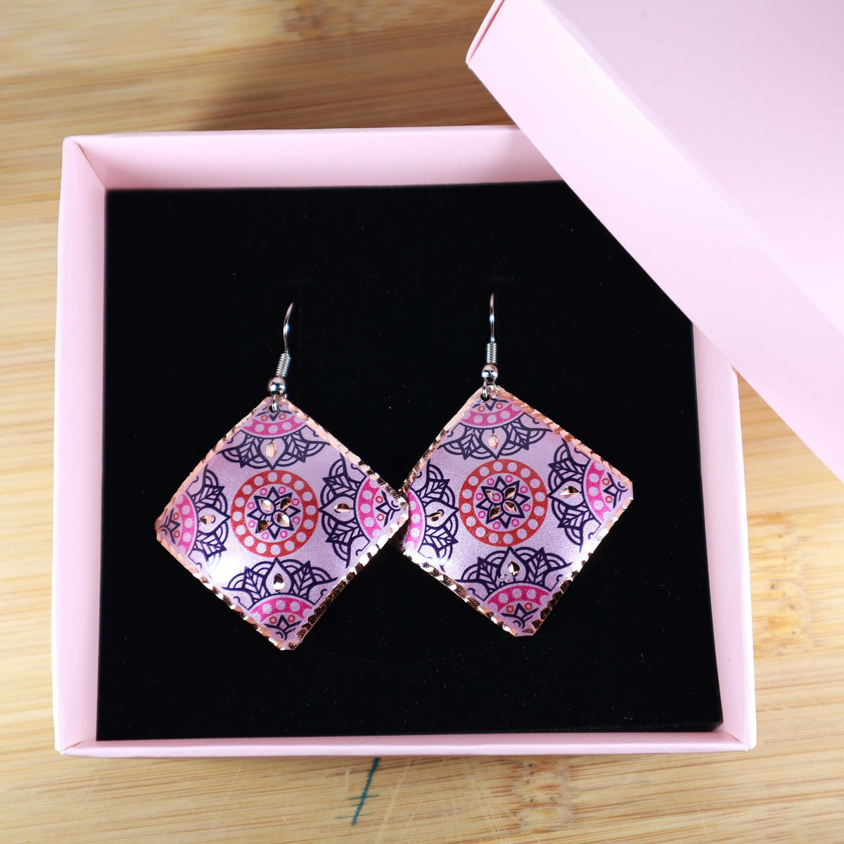 Back view of handcrafted artisan pink copper square earrings