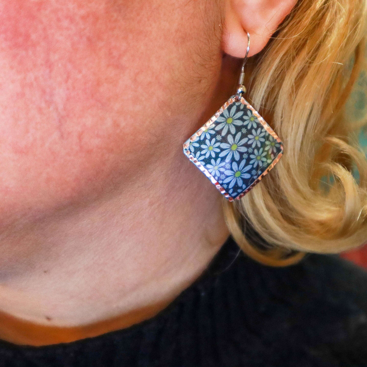 Side angle of artisan turquoise flower copper square earrings